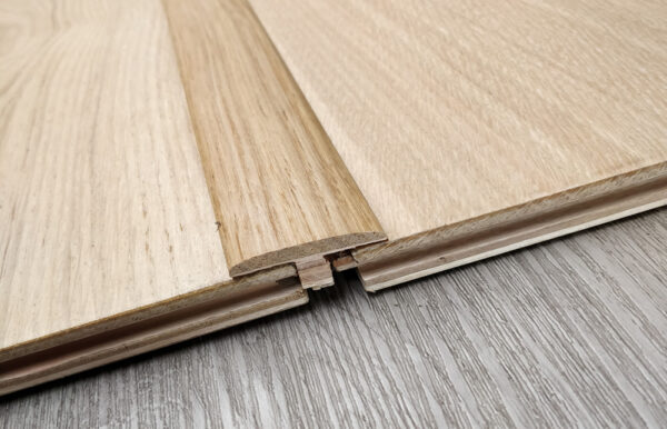 The Wooden Expansion Transition Trim, crafted entirely from high-quality, 100% solid wood, is a fundamental accessory for any flooring installation.